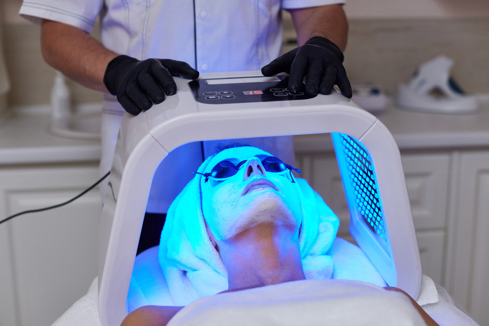 Woman Getting Facial Treatment with Led .